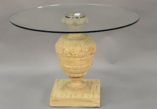 Round glass top table with carved wood pedestal base.
