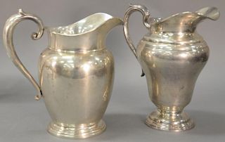 Two sterling silver water pitchers. ht. 9 1/2" & 9 1/4", 40.7 t oz.