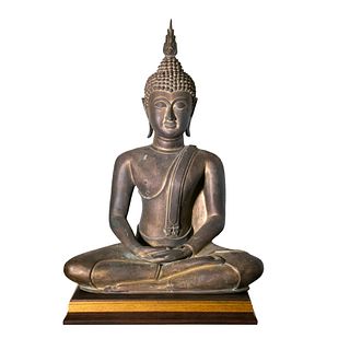 A metal Buddha statue  | พระพุทธรูป