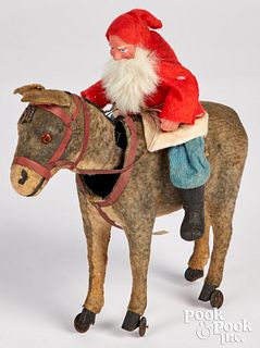 Composition Santa Claus riding a nodding donkey