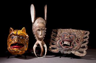 Group of Three Carved Wooden Masks, 20th c., one A