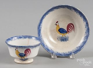 Blue spatter cup and saucer with rooster decoration.