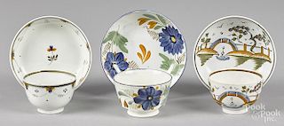 Three English pearlware cups and saucers, 19th c.