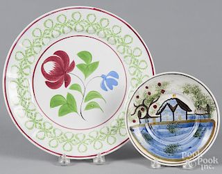 Stick spatter plate, 10'' dia., together with a saucer with house decoration, 6'' dia.