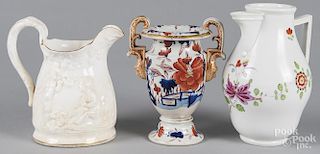 Molded pottery pitcher, together with a Meissen style pitcher and a crown derby urn