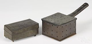 Tin wrigglework spice box, 19th c., 2 3/4'' h., 6 1/4'' w., together with a punched tin warmer