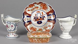 Two Chinese export porcelain helmet creamers, 19th c., together with a soap dish and an Imari plate.