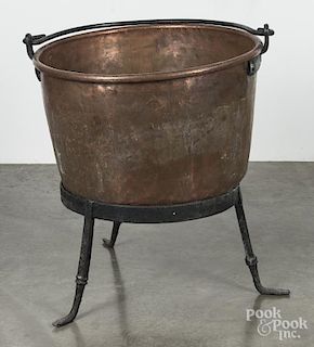 Copper apple butter kettle with an iron stand, 33'' h., 28'' w.