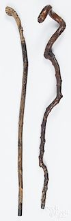 Two carved canes, early 20th c., one with a Native American in a headdress on the grip, 37'' l.