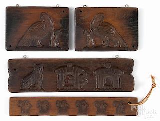 Four carved wood food molds, largest - 3'' h., 11 3/4'' w.