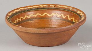 Pennsylvania or Maryland redware bowl, 19th c., with yellow and green slip decoration, 2 3/4'' h.