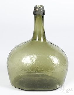 Emerald green bottle, 10'' h., together with a reverse painted glass fish plaque, 11'' h.