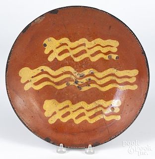 Pennsylvania redware charger, 19th c., with yellow slip decoration, 11 1/4'' dia.