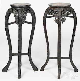 Two Chinese carved hardwood stands, early 20th c., with marble inset tops, 35 1/4'' h.