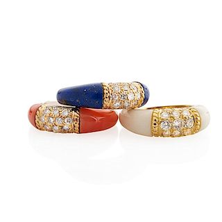 THREE CARVED CORAL HARDSTONE OR DIAMOND & YELLOW GOLD STACKING RINGS