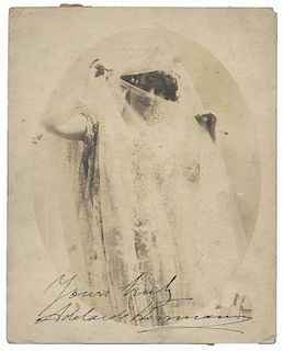 Herrmann, Adelaide. Inscribed and signed portrait of Adelaide Herrmann. New York: Apeda, ca. 1917. Three-quarter length image shows Adelaide peeking o