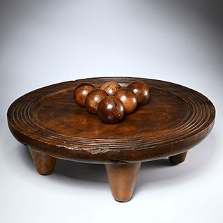 Artisan carved wood spheres on game board stand