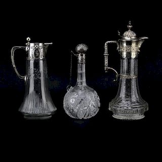 Lot of Three Cut Glass Decanters. Includes a Sterling Lidded bottle Marked Sterling