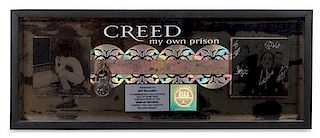 An Autographed Creed: My Own Prison RIAA Certified 4x Platinum Presentation Album 12 x 31 inches.