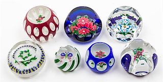 * A Collection of Seven Glass Paperweights Width of largest 3 1/8 inches.