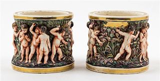 * A Pair of Putti Covered Cache Pots Height 6 inches.