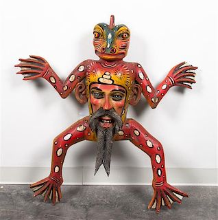 * A Mexican Painted Wood Figural Mask Height 37 inches.