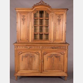 A French Carved Walnut Buffet a Deux Corps in the French Provincial Style, 19th/20th Century.