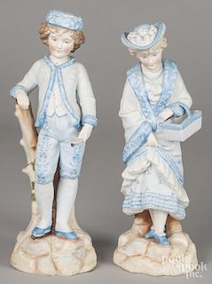 Pair of bisque figures of a boy and girl in blue, 12 3/4'' h.