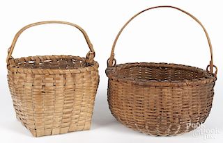 Two split oak baskets with swing handles, ca. 1900, 8'' h., 11 1/4'' w. and 7'' h., 13 1/2'' w.