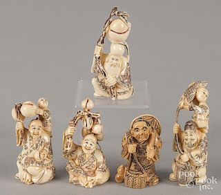 Five Japanese carved ivory netsukes.