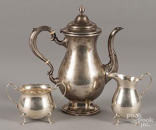 Sterling silver teapot, together with a matched creamer and sugar, 30.2 ozt.
