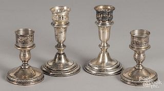 Two pairs of weighted sterling silver candlesticks, 4 3/4'' h. and 6 1/2'' h.