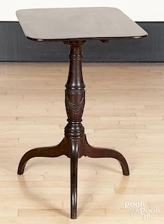 Federal mahogany candlestand, 19th c., with a swag carved standard, 28 1/2'' h., 17 3/4'' w., 23'' d.