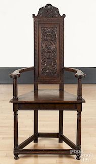 Jacobean style carved oak hall chair.