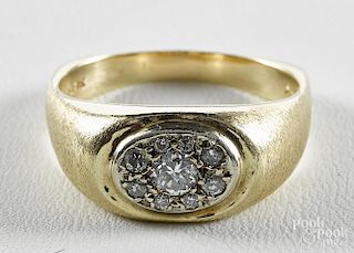 14K yellow gold ring with a cluster of round, brilliant cut diamonds, including a center diamond