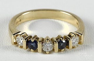 Gold, diamond, and sapphire ring, the 14K yellow gold band with alternating round cut blue sapphires