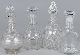 Four colorless glass decanters, tallest - 11 1/2''.