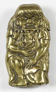 Embossed brass man with frogs match vesta safe of a kneeling man holding a frog wearing a hat
