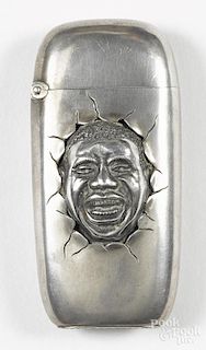 Nickel-plated black Americana match vesta safe depicting the face of a smiling black man