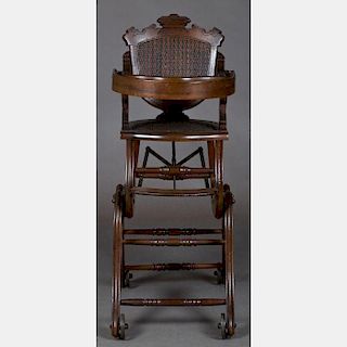 A Victorian Walnut Transforming Doll's Rolling High Chair and Stroller, 19th Century.