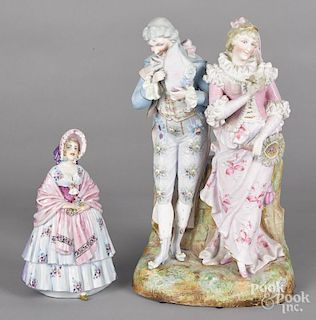 Bisque figure of a man and woman, 14 1/2'' h., together with a porcelain double-sided figure, 9'' h.