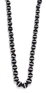 * A Single Strand Graduated Banded Onyx Bead Necklace,