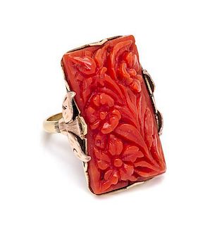 An 18 Karat Bicolor Gold and Carved Coral Ring, 5.90 dwts.