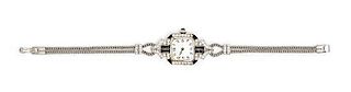 * An Art Deco Platinum, Diamond and Onyx Wristwatch, C.H. Meylan for Henry Blank & Co., 18.00 dwts.