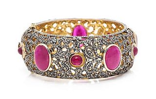 A Silver Topped Gold, Treated Ruby and Diamond Bangle Bracelet, 53.00 dwts.