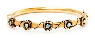 A 14 Yellow Gold and Opal Bangle Bracelet, 10.20 dwts.