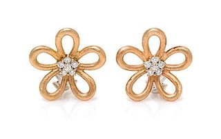 A Pair of Bicolor Gold and Diamond Flower Motif Earclips, 10.10 dwts.