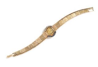 A 14 Karat Yellow Gold, Diamond and Sapphire Wristwatch, MOBA, 9.60 dwts.