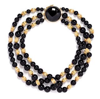 * A Triple Strand Yellow Gold and Onyx Bead Necklace, 63.30 dwts.