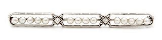 An Art Deco Platinum, Diamond and Seed Pearl Bar Brooch. 3.80 dwts.